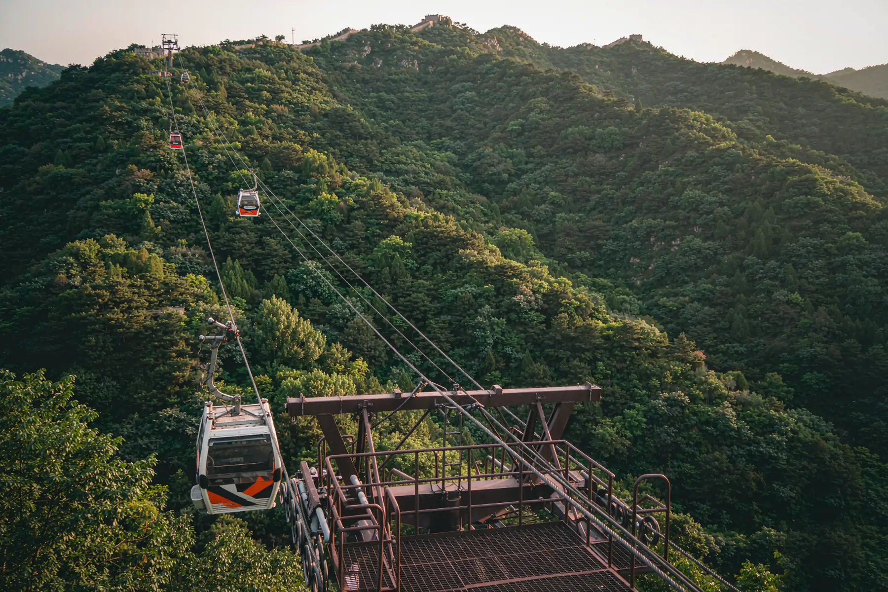 Mutianyu Great Wall winding over green hills in morning light — Beijing private tour
